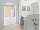 Bright bathroom with a large mirror, vanity with wood cabinets, and a tub at 150 Golfside Cir, Sanford, FL 32773