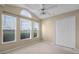 Bedroom featuring large windows with blinds, a ceiling fan, and a closet at 150 Golfside Cir, Sanford, FL 32773