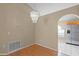 Cozy dining area featuring hardwood floors, a modern chandelier, and an archway leading to a kitchen at 150 Golfside Cir, Sanford, FL 32773