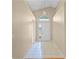 Inviting foyer with tile flooring, neutral walls, and an arched window over a white front door and sidelight at 150 Golfside Cir, Sanford, FL 32773
