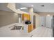 Bright kitchen featuring a stainless sink, modern appliances, and a skylight at 150 Golfside Cir, Sanford, FL 32773