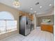 Spacious kitchen with stainless appliances, a window, and an adjacent eating area at 150 Golfside Cir, Sanford, FL 32773