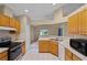 Bright kitchen with stainless appliances, tile flooring, and a view to other rooms at 150 Golfside Cir, Sanford, FL 32773