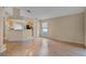 Spacious living room with hardwood floors and natural light open to kitchen at 150 Golfside Cir, Sanford, FL 32773