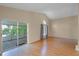 Spacious living room boasts hardwood floors and access to a screened-in porch overlooking a lake at 150 Golfside Cir, Sanford, FL 32773