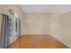 Bright living room features hardwood floors and a window overlooking a garden at 150 Golfside Cir, Sanford, FL 32773