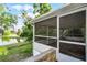 A comfortable screened porch provides relaxing views of the pond and lush lawn at 150 Golfside Cir, Sanford, FL 32773