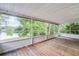 Enjoy outdoor living with a screened porch featuring a lake view and plank floors at 150 Golfside Cir, Sanford, FL 32773