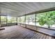 A spacious screened porch has tongue-and-groove wood flooring and great lake views at 150 Golfside Cir, Sanford, FL 32773