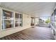 Enjoy a screened lanai with beautiful wood floors, offering a serene view at 150 Golfside Cir, Sanford, FL 32773