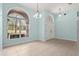 Bright entryway featuring tile flooring, a large window, and high ceilings with decorative lighting at 10827 Lemay Dr, Clermont, FL 34711