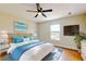 Bright bedroom with a comfortable bed, ceiling fan, and large window, offering a relaxing retreat at 1402 Missouri Pl, Poinciana, FL 34759