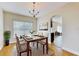 Bright dining room featuring a chandelier, stylish table set, and neutral colors, creating an inviting space at 1402 Missouri Pl, Poinciana, FL 34759
