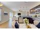 Well-equipped kitchen with modern stainless appliances, dark cabinets, and a view of the open-concept living space at 1402 Missouri Pl, Poinciana, FL 34759