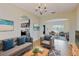 Cozy living room with comfortable seating, stylish decor, and a view into the kitchen and front entry at 1402 Missouri Pl, Poinciana, FL 34759