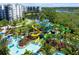 Aerial view of a waterpark with colorful slides, pools, and lush landscaping at 14501 Grove Resort Ave # 3222, Winter Garden, FL 34787