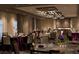 Elegant banquet hall with formal tables, linens, and ornate chandelier lighting at 14501 Grove Resort Ave # 3222, Winter Garden, FL 34787
