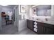 Modern bathroom featuring double sinks, sleek fixtures, and ample storage space near a walk-in closet at 14501 Grove Resort Ave # 3222, Winter Garden, FL 34787
