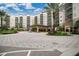 A large multi-story resort-style building with a covered entrance and well-maintained landscaping at 14501 Grove Resort Ave # 3222, Winter Garden, FL 34787