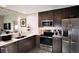 Modern kitchen featuring stainless steel appliances, gray cabinets, and bright countertops at 14501 Grove Resort Ave # 3222, Winter Garden, FL 34787