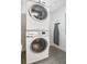 A laundry room featuring a stacked washer and dryer and includes an ironing board at 14501 Grove Resort Ave # 3222, Winter Garden, FL 34787