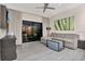 Inviting living room with a comfortable sofa, stylish furniture, and a serene ambiance with sliding glass doors at 14501 Grove Resort Ave # 3222, Winter Garden, FL 34787