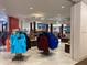 A store with neatly organized racks and display tables filled with various clothing items at 14501 Grove Resort Ave # 3222, Winter Garden, FL 34787