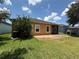 Exterior shot showcasing the home's backyard, featuring a patio and lush green lawn at 2815 Moonstone Bnd, Kissimmee, FL 34758
