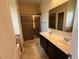 A bathroom featuring a double sink vanity, granite countertop, and tiled walk-in shower at 2815 Moonstone Bnd, Kissimmee, FL 34758