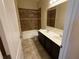 Bathroom features double sinks, tile flooring, and a tub with a shower at 2815 Moonstone Bnd, Kissimmee, FL 34758