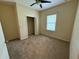 This bedroom features neutral walls, a ceiling fan, closet and a window overlooking the exterior at 2815 Moonstone Bnd, Kissimmee, FL 34758
