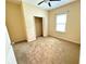 This bedroom features neutral walls, a ceiling fan, closet and a window overlooking the exterior at 2815 Moonstone Bnd, Kissimmee, FL 34758