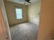 This bedroom features neutral walls, a ceiling fan, and a window overlooking the exterior at 2815 Moonstone Bnd, Kissimmee, FL 34758