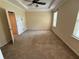 This bedroom features neutral walls, a ceiling fan, and a window overlooking the exterior at 2815 Moonstone Bnd, Kissimmee, FL 34758