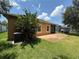 A home's backyard featuring a patio, lush lawn, and well-maintained exterior for outdoor enjoyment at 2815 Moonstone Bnd, Kissimmee, FL 34758