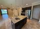 Modern kitchen island boasts granite countertops, stainless steel appliances and pendant lighting at 2815 Moonstone Bnd, Kissimmee, FL 34758