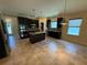 Spacious kitchen features dark cabinetry, stainless steel appliances, and an island with granite countertops at 2815 Moonstone Bnd, Kissimmee, FL 34758