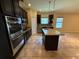 Stylish kitchen features stainless steel appliances, granite countertops, and dark wood cabinetry at 2815 Moonstone Bnd, Kissimmee, FL 34758