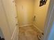 A laundry room featuring tiled floors, a washer and dryer hook-up, and storage at 2815 Moonstone Bnd, Kissimmee, FL 34758