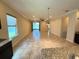Well-lit, expansive living room with sliding glass doors provides an indoor-outdoor flow at 2815 Moonstone Bnd, Kissimmee, FL 34758