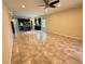 Open-concept living room has tile flooring and great lighting, flowing seamlessly into the kitchen at 2815 Moonstone Bnd, Kissimmee, FL 34758