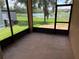 Screened patio with view of lush lawn and serene lake offering peaceful outdoor living at 2815 Moonstone Bnd, Kissimmee, FL 34758