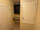 This storage room features a desk and cabinet, tiled floors, and a white door at 2815 Moonstone Bnd, Kissimmee, FL 34758