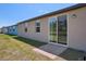 The exterior showcases a sliding glass door leading to a small patio in the backyard at 3218 Viceroy Ct, Poinciana, FL 34759