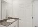 The bathroom features granite countertop, white cabinets, and a large mirror at 3218 Viceroy Ct, Poinciana, FL 34759