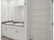 Bathroom showcasing double sinks with granite countertops, cabinetry and shelving at 3218 Viceroy Ct, Poinciana, FL 34759