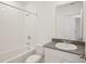 This bathroom has a shower and tub combo with a granite vanity at 3218 Viceroy Ct, Poinciana, FL 34759