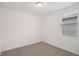 This carpeted bedroom is bright and well lit with neutral walls and a window at 3218 Viceroy Ct, Poinciana, FL 34759