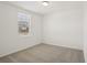 This carpeted bedroom is bright and well lit with neutral walls and a window at 3218 Viceroy Ct, Poinciana, FL 34759