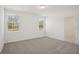 Bright bedroom with neutral carpet, white walls, and window views with natural light at 3218 Viceroy Ct, Poinciana, FL 34759